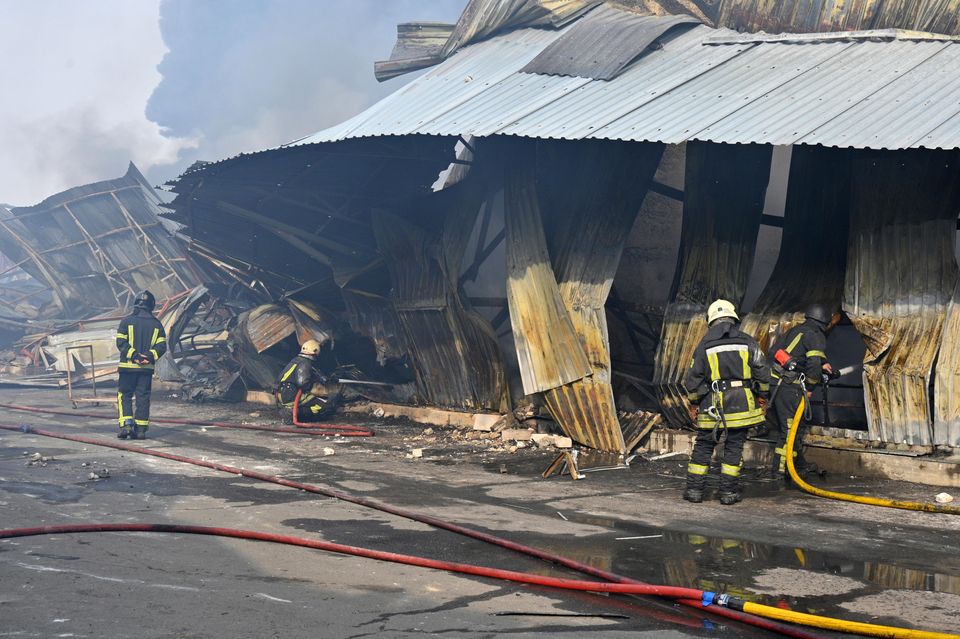 Firefighters put out a blaze following a Russian drone attack that hit warehouses in Odesa, Ukraine (Michael Shtekel/AP)