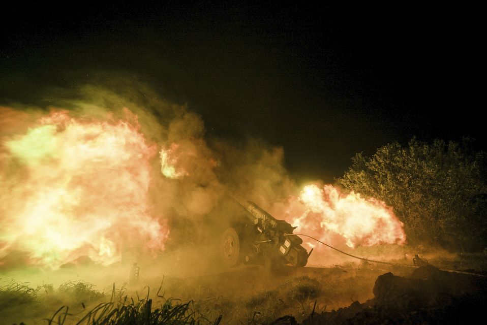 Ukrainian servicemen fire from a 122mm artillery cannon towards Russian positions in Kherson region, Ukraine, on Sunday (Marko Ivkov/AP)