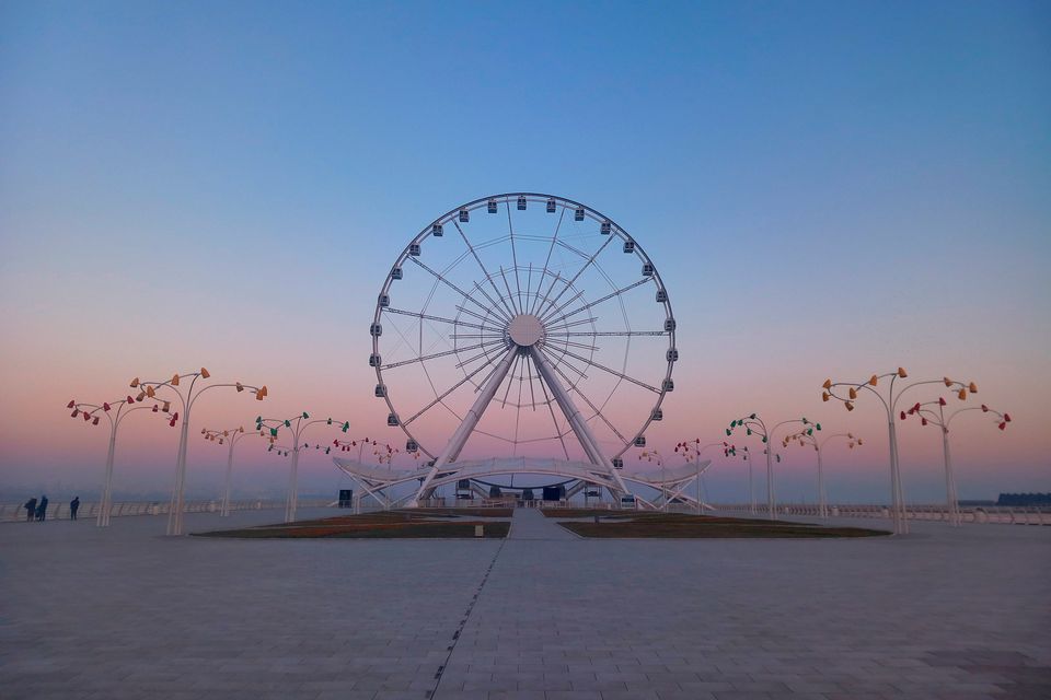 A ferris wheel on the waterfront