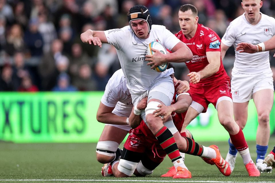 Ulster's James McNabney looks to escape the attention of his Scarlets counterpart Dan Davis