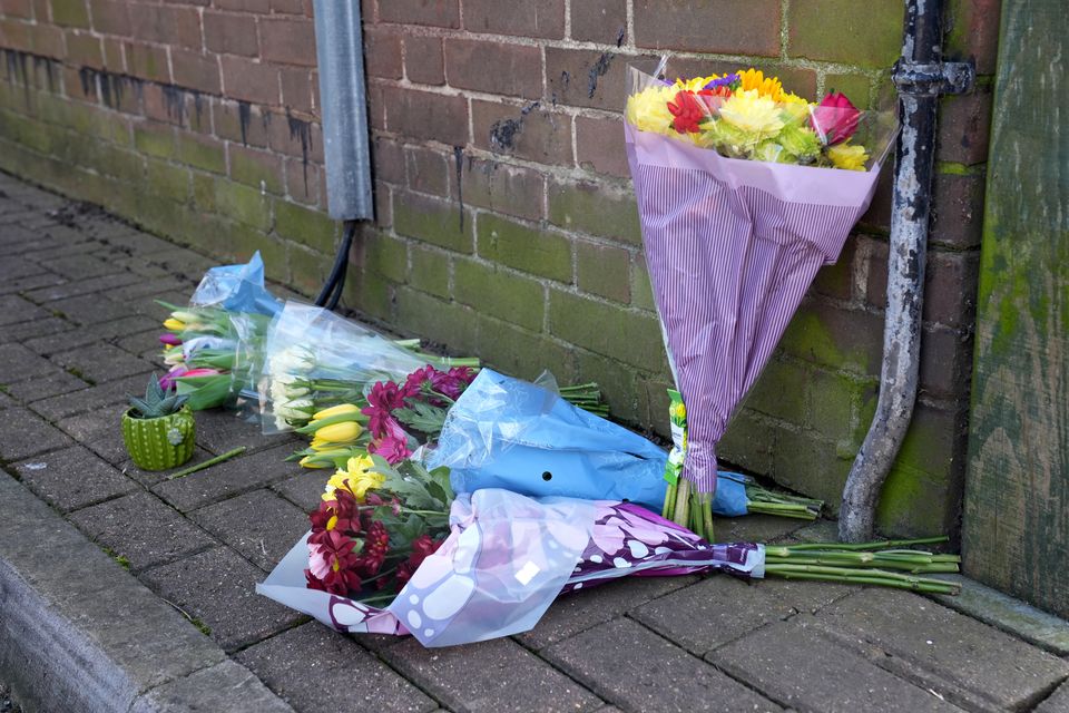 Floral tributes have been left near the scene of the fatal shooting (Lucy North/PA)