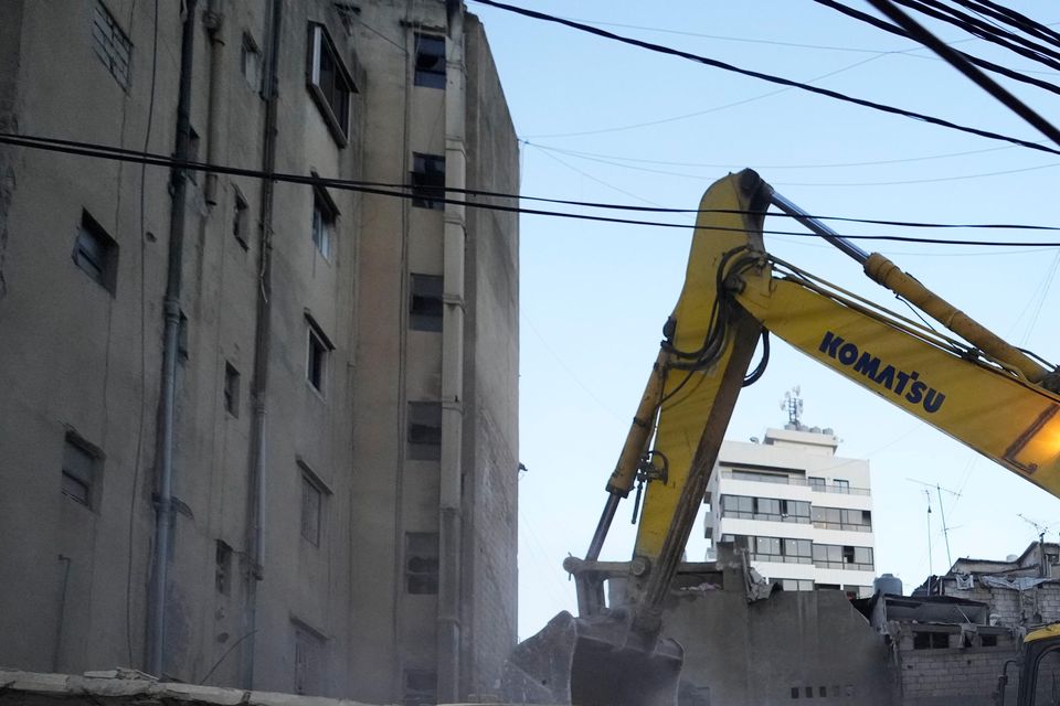 Rescuers use an excavator as they search for victims at the site of an Israeli air strike in Beirut, Lebanon (Hassan Ammar/AP)