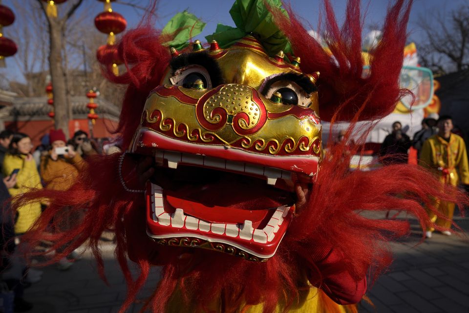 Lion dances, as seen here at the Dongyue Temple in Beijing, are a common feature of the Spring Festival (AP)