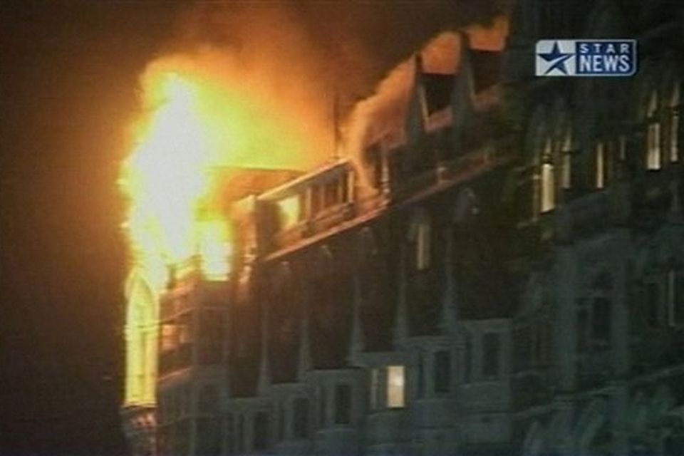 Flames erupt from the Taj Mahal hotel in Mumbai, India in this image made from television, Wednesday, Nov. 26, 2008. Teams of heavily armed gunmen stormed luxury hotels, a popular restaurant and a crowded train station in coordinated attacks across India's financial capital Wednesday night, killing at least 78 people and taking Westerners hostage, police said. A previously unknown group, apparently Muslim militants, took responsibility for the attacks. A raging fire and explosions struck one of the hotels, the landmark Taj Mahal, early Thursday.  (AP Photo/STAR NEWS)  **  INDIA OUT  TV OUT  **