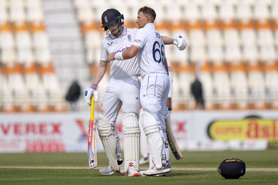 Root, right, is congratulated by Harry Brook after scoring his century (Anjum Naveed/AP)