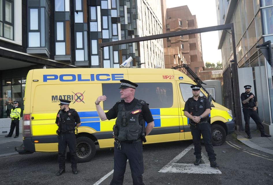 Police officers and a police van block the vehicle entrance at Liverpool Magistrates’ Court (Danny Lawson/PA)