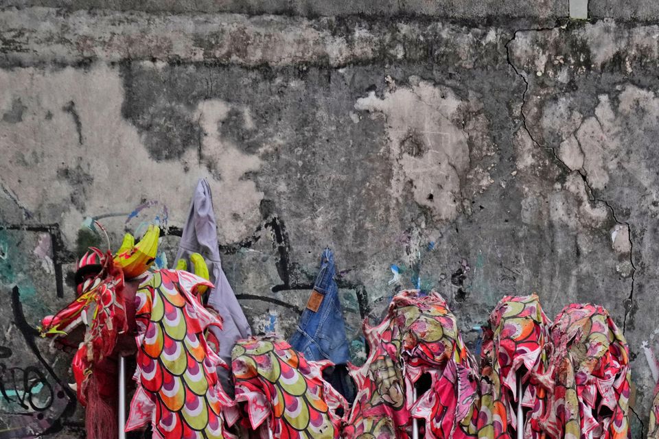 Members of dragon dance club Naga Merah Putih (Red White Dragon), named after the Indonesian national colours, take a break during training in Bogor, West Java (Dita Alangkara/AP)