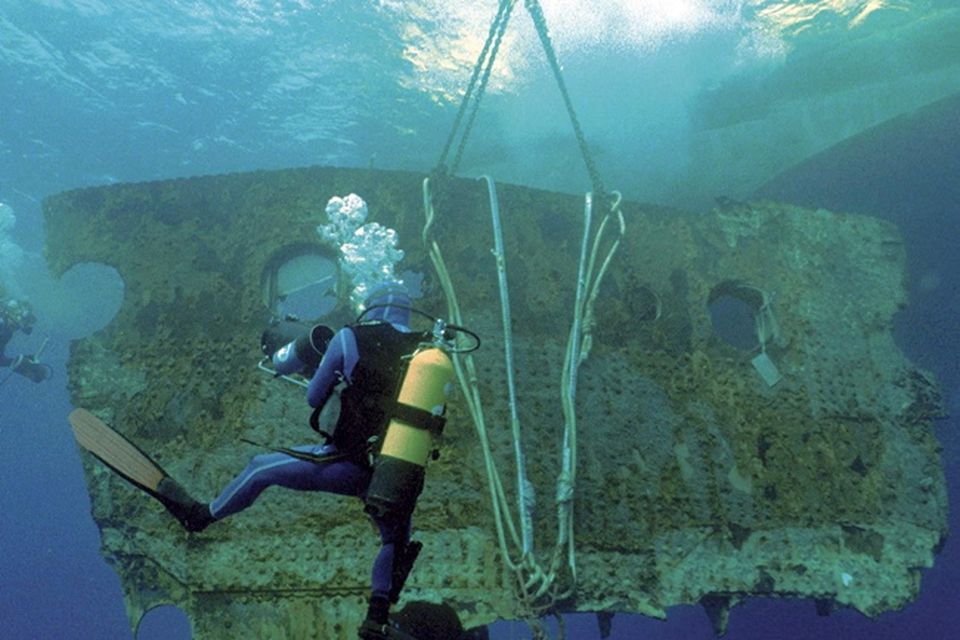 A diver accompanies a 17-ton portion of the hull of the Titanic as it is lifted to the surface in the Atlantic Ocean.