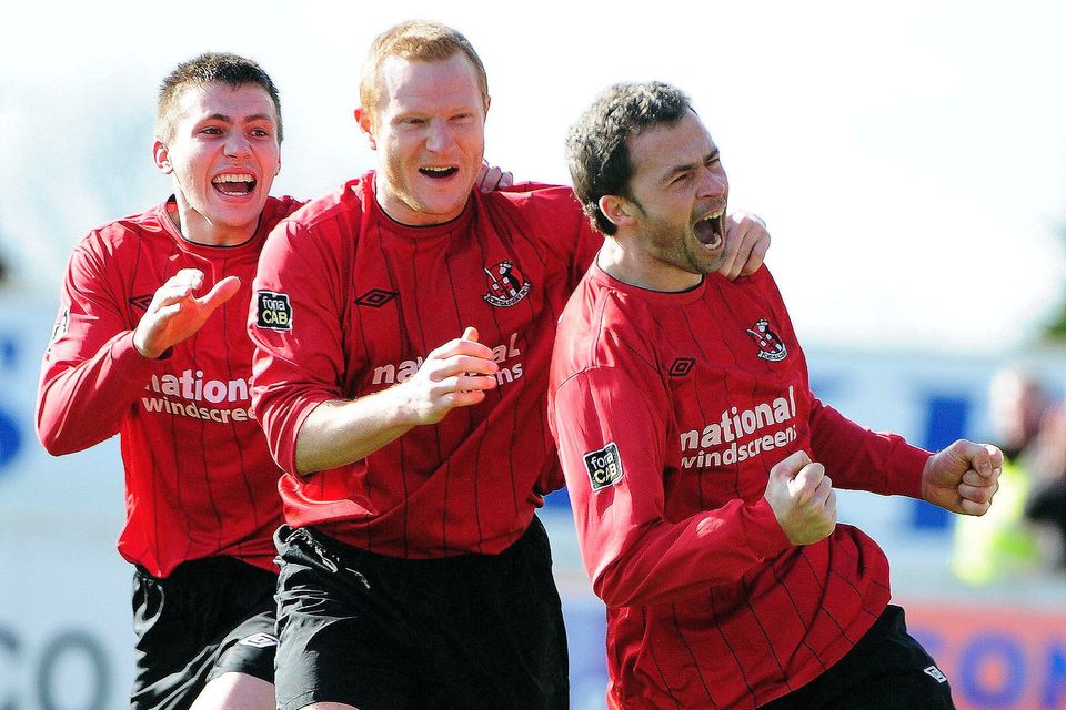 Stuart Dallas (left) helps David Rainey (right) celebrate a goal in Crusaders' 2012 Irish Cup Semi-Final clash with Dungannon Swifts
