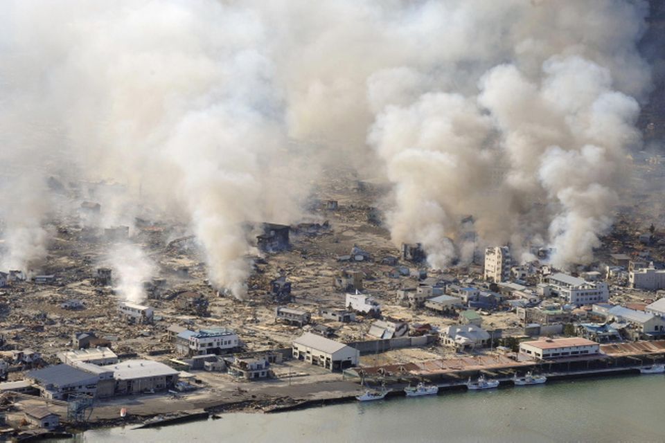 White smokes rise from still burning house in Yamadamachi in Iwate Prefecture (state), northern Japan, Saturday, March 12, 2011, one day after a strong earthquake-triggered devastating tsunami hit the area