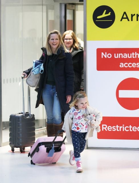 Aurelia Hearte (4) runs to meet her Grand parents after arriving at Belfast City Airport with her mother Julia, left, for  the Christmas holidays, Friday, Dec. 2024.  (Picture by Peter Morrison)