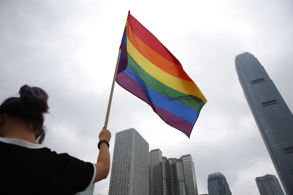 A participant holds a rainbow flag at the annual Pride Parade in Hong Kong in 2018 (Kin Cheung/AP)