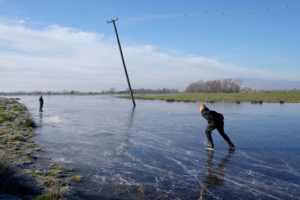 People used a frozen field in Upware, Cambridgeshire, as an ice-staking rink (Joe Giddens/PA)