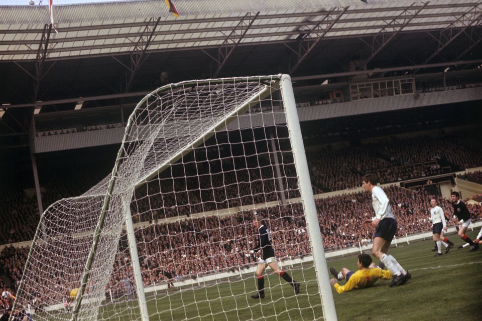 Denis Law celebrates scoring for Scotland against England (PA).