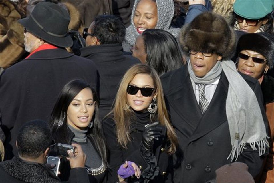 Jay-Z, Beyonce and Solange Knowles, left, stop for a photo as they try to find their seats as they arrive for the inauguration ceremony at the U.S. Capitol in Washington, Tuesday, Jan. 20, 2009.  (AP Photo/Jae C. Hong)