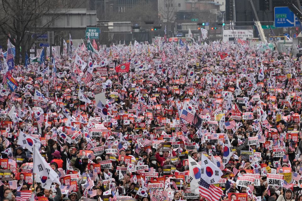 Police said tens of thousands of people rallied in the streets near the court (Ahn Young-joon/AP)