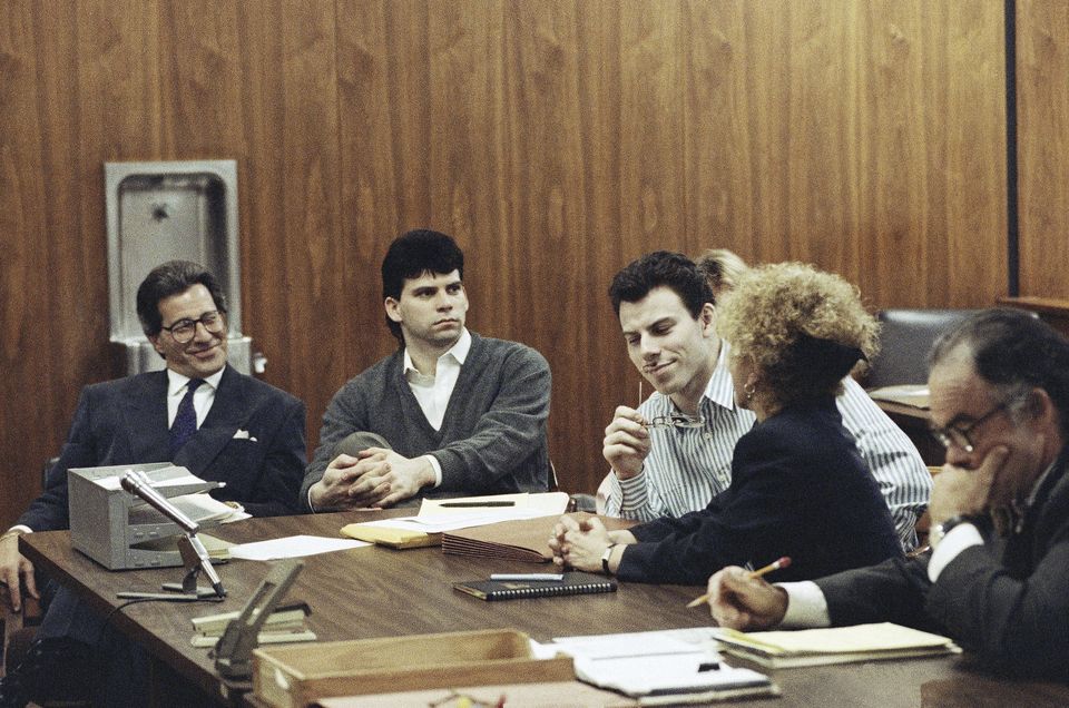 Erik Menendez, centre, listens to his lawyer Leslie Abramson as his brother Lyle looks on in court in 1991 (Julie Markes/AP)