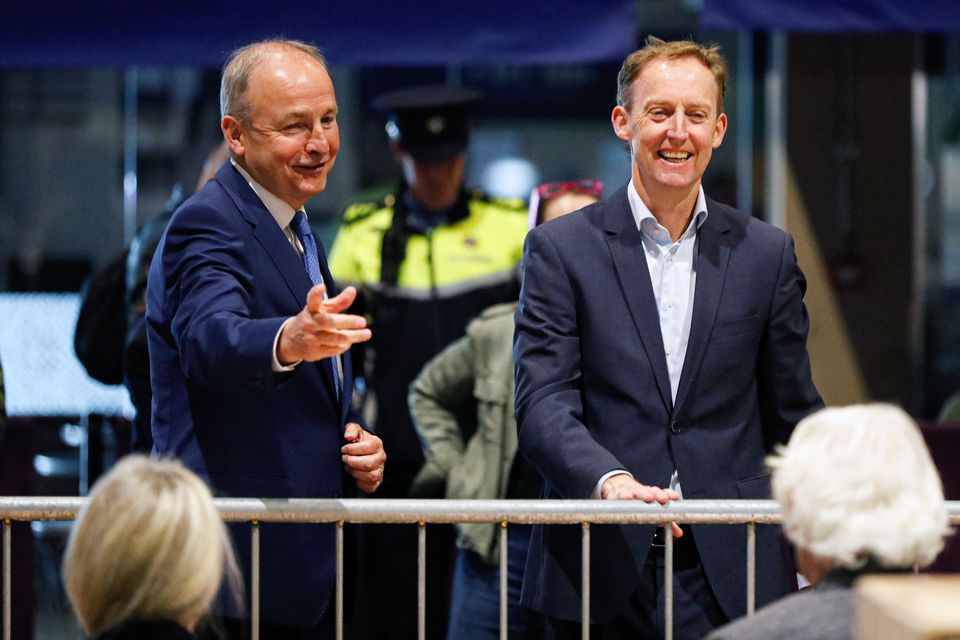 Fianna Fail election candidate Barry Andrews (right) and Tanaiste Micheal Martin at the RDS count centre on Monday (Damien Storan/PA)