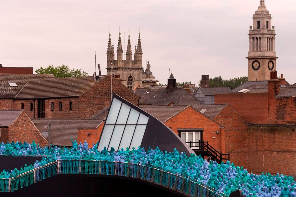 Naked volunteers, painted in blue to reflect the colours found in Marine paintings in Hull's Ferens Art Gallery, participate in US artist, Spencer Tunick's "Sea of Hull" installation on the Scale Lane swing bridge in Kingston upon Hull on July 9, 2016. AFP/Getty Images