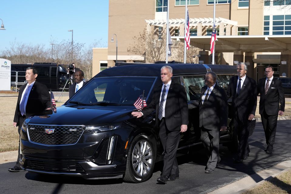 Former and current US Secret Service agents walk with the hearse (Alex Brandon/AP)