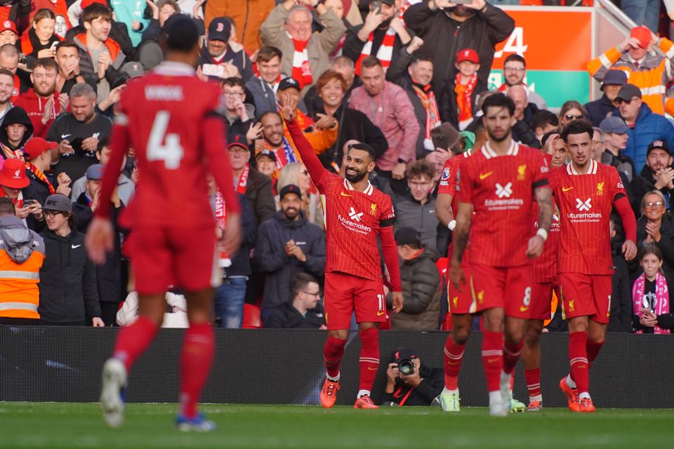 Mohamed Salah (centre) celebrates scoring Liverpool’s opener from the penalty spot (Peter Byrne/PA)