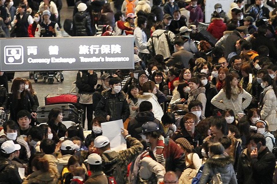 Thousands queue to get on flights at Narita International airport to evacuate Japan (AP)