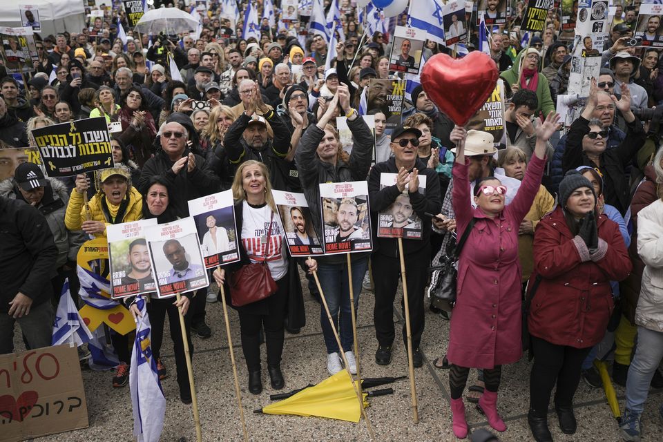 Israelis react as the first two of six hostages to be released in Gaza are handed over to the Red Cross as they watch a live broadcast in Hostages Square in Tel Aviv, Israel (Oded Balilty/AP)