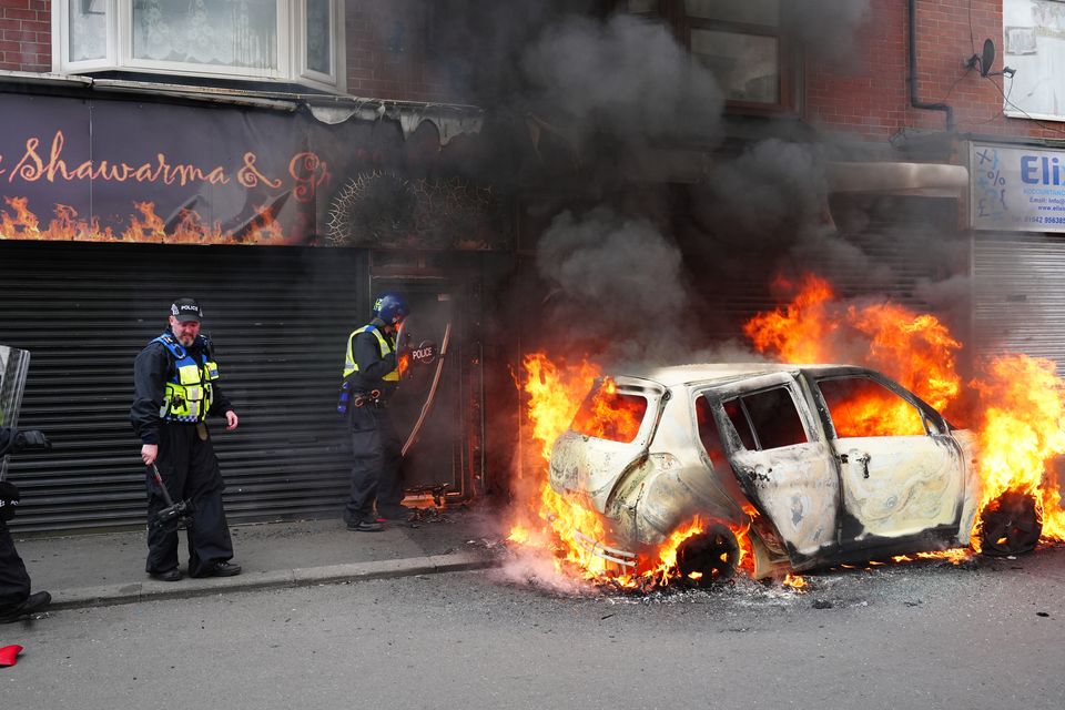 A car burns on Parliament Road in Middlesbrough, one of a number of English towns hit by unrest (Owen Humphreys/PA)