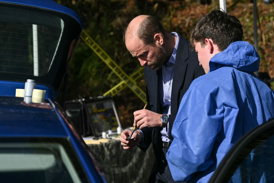 William tries his hand at dusting for fingerprints (Justin Tallis/PA)