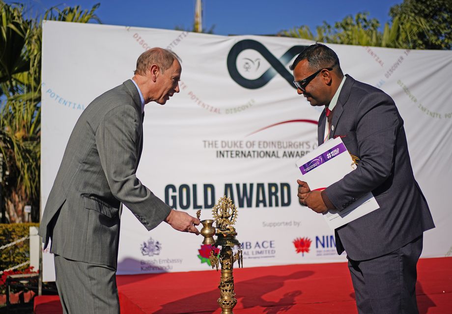 The Duke of Edinburgh (left) and the chair of the Duke of Edinburgh International Award Nepal, Dev Raj Ghimire, light a lamp ahead of an awards ceremony at the British embassy (Yui Mok/PA)