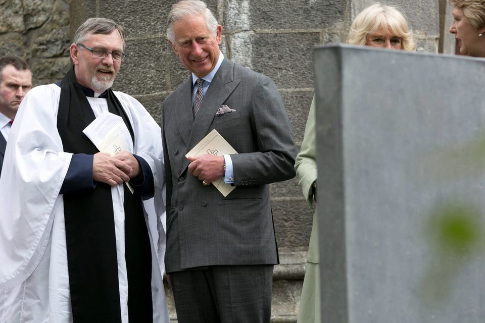 The Prince of Wales (centre) and the Very Rev. Arfon Williams at the grave of WB Yeats after attending a peace and reconciliation prayer service at St. Columba's Church in Drumcliffe on day two of a four day visit to Ireland. PRESS ASSOCIATION Photo. Picture date: Wednesday May 20, 2015. See PA story ROYAL Ireland. Photo credit should read: Colm Mahady/PA Wire