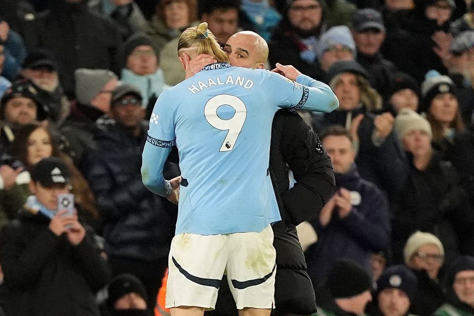 Manchester City manager Pep Guardiola, right, speaks to Erling Haaland (Martin Rickett/PA)