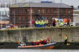 thumbnail: Emergency teams help rescue the woman on the banks of the River Lagan. Pic Liam McBurney/RAZORPIX