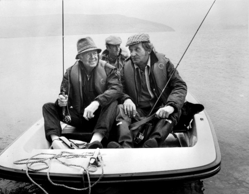 Jimmy Carter (left), trout fishing with Western Mail fishing expert Moc Morgan on Clywedog Reservoir, near Llanidloes, in Wales in 1986 (PA)