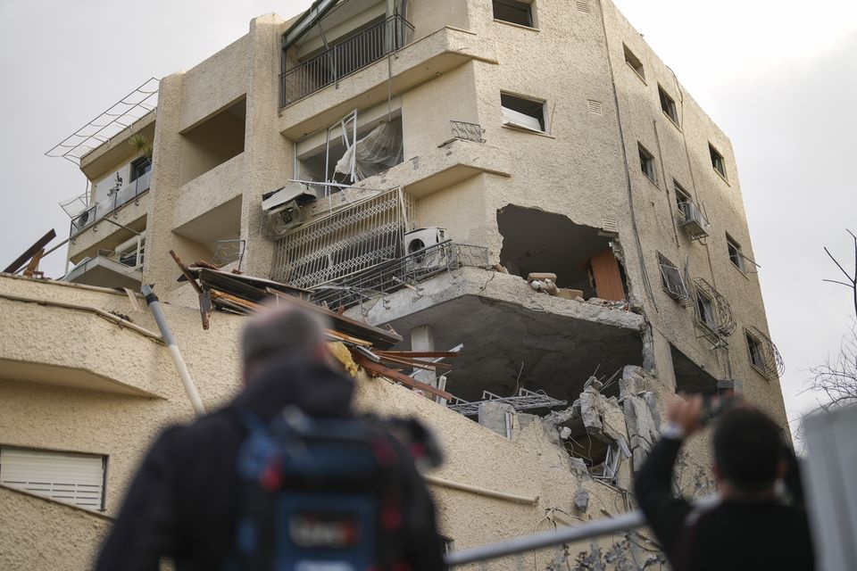 Journalists take pictures of a damaged building in Haifa, Israel (Francisco Seco/AP)