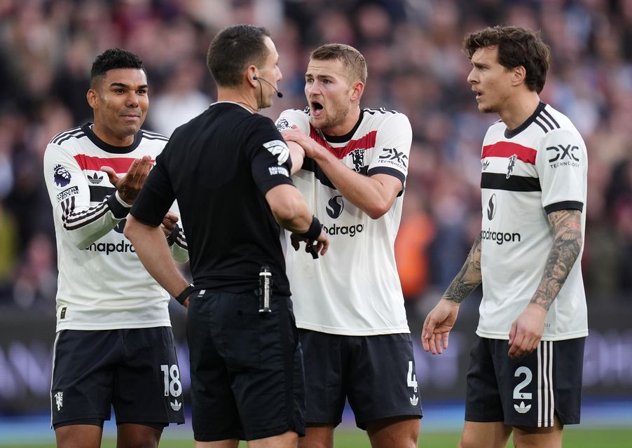 Manchester United’s Matthijs de Ligt (centre right) protests to referee David Coote (centre left) after he awarded a penalty to West Ham (John Walton/PA)