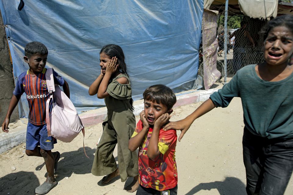 Palestinian children are evacuated from a site hit by an Israeli bombardment on Khan Younis, southern Gaza Strip (AP Photo/Jehad Alshrafi, File)