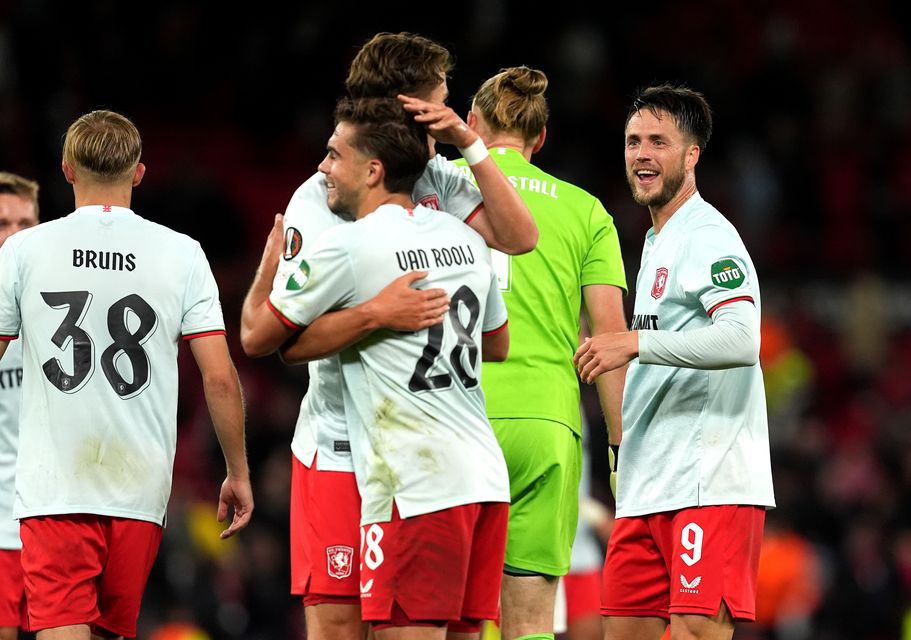 FC Twente players celebrate following the draw at Old Trafford (Martin Rickett/PA)