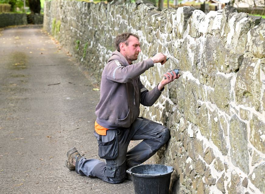 Nathan lime pointing a stonewall (Mandatory Credit: Stephen Hamilton)