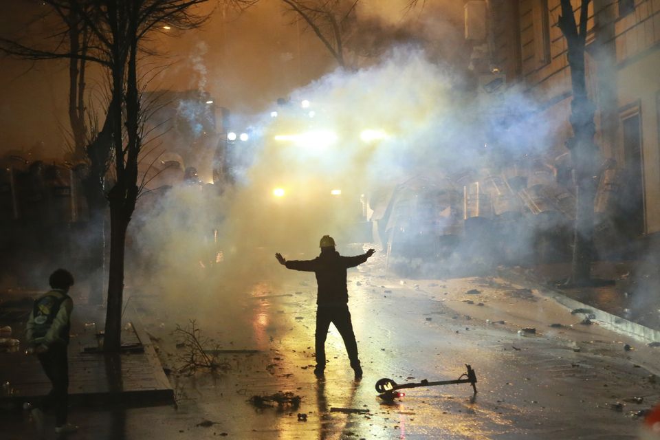 A demonstrator gestures as police block a street in Tbilisi, Georgia (Zurab Tsertsvadze/AP)