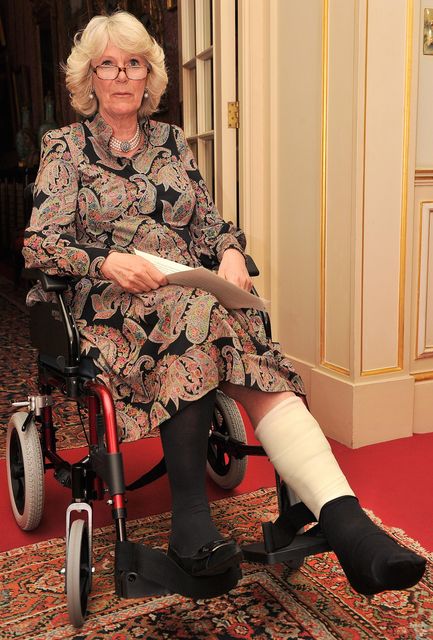 The then Duchess of Cornwall with a cast and in a wheelchair on her first official appearance in 2010 after breaking her leg (Leon Neal/PA)