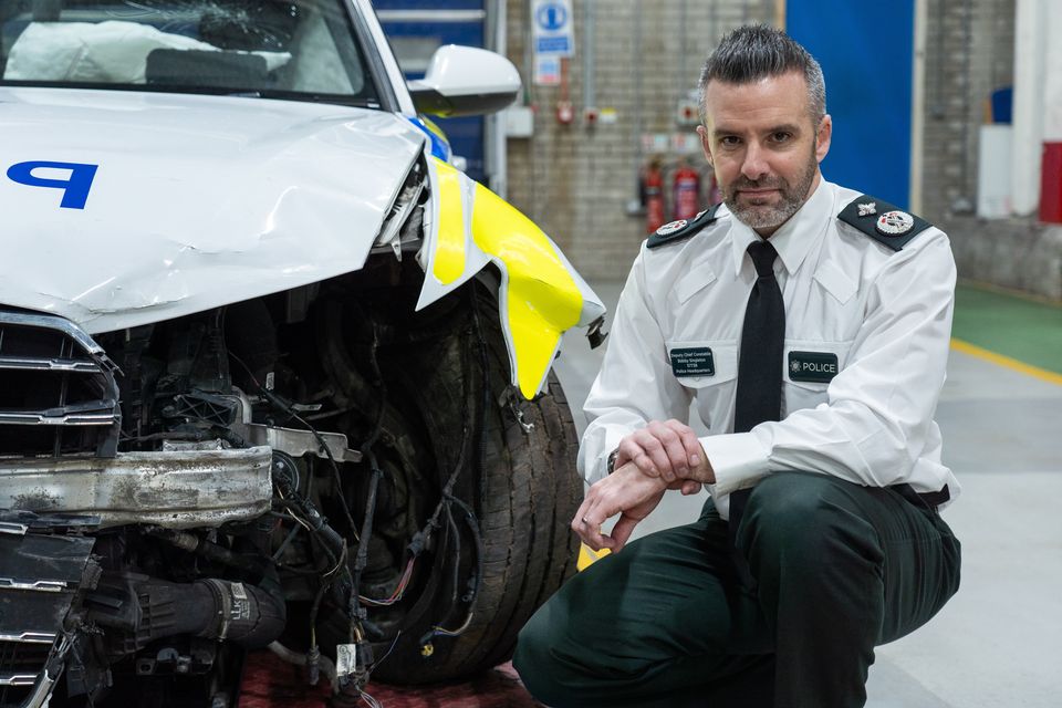 Deputy Chief Constable Bobby Singleton with a damaged police car (Photo by Luke Jervis / Belfast Telegraph)