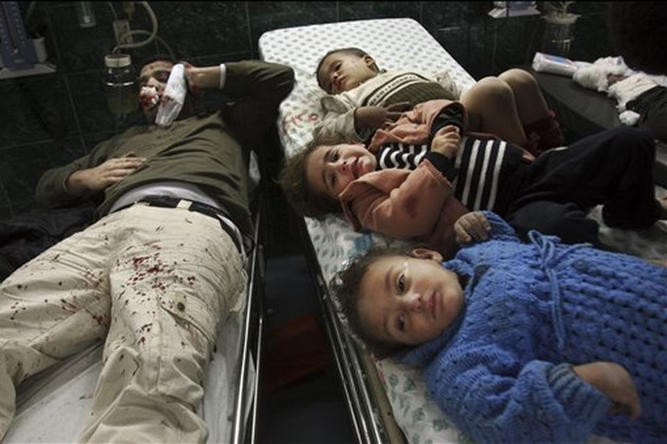 Palestinian children and a man wounded in Israeli missile strikes are seen in the emergency area at Shifa hospital in Gaza City, Saturday, Dec. 27, 2008. Israeli warplanes demolished dozens of Hamas security compounds across Gaza on Saturday in unprecedented waves of simultaneous air strikes. Gaza medics said at least 145 people were killed and more than 310 wounded in the single deadliest day in Gaza fighting in recent memory. (AP Photo/Khalil Hamra)