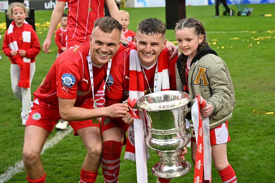 Rory and Ronan Hale show off the Irish Cup after Cliftonville's victory over Linfield