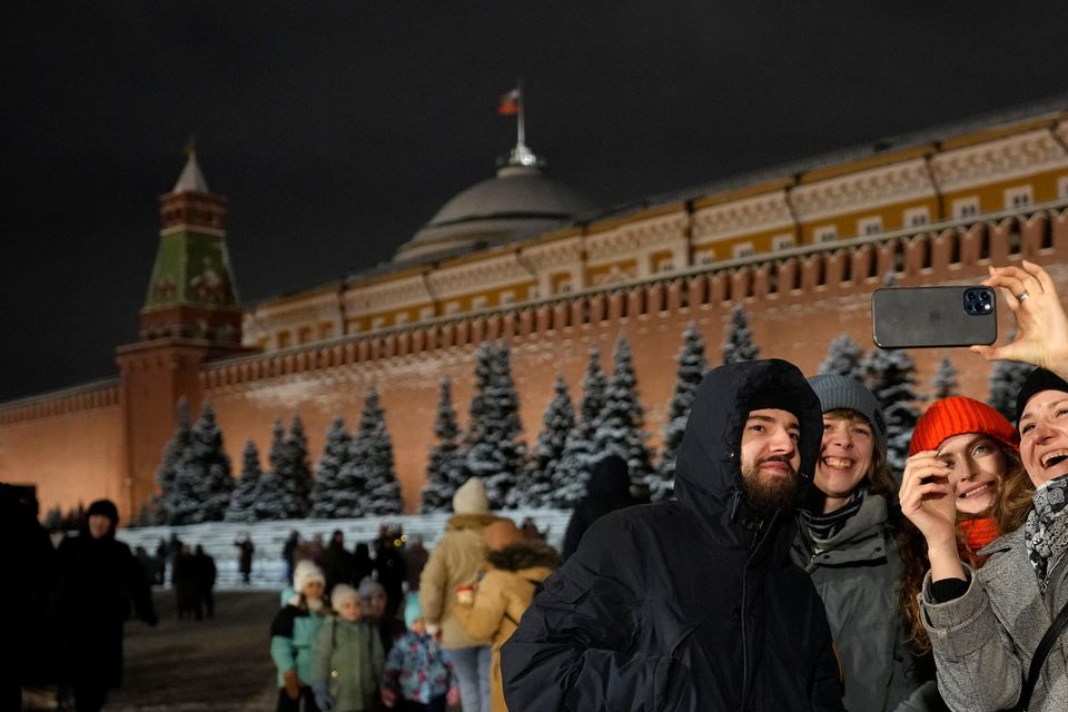 People take a selfie in the Red Square prior to its closure for celebrations (AP Photo/Pavel Bednyakov)