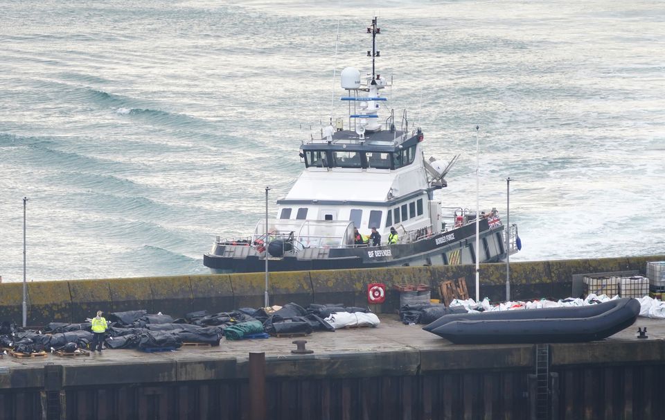 Border Force officers investigate boats thought to be used by migrants on the dockside in Dover, Kent (Gareth Fuller/PA)