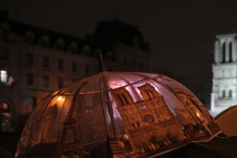 Spectators gather outside Notre Dame Cathedral (Alessandra Tarantino/AP)