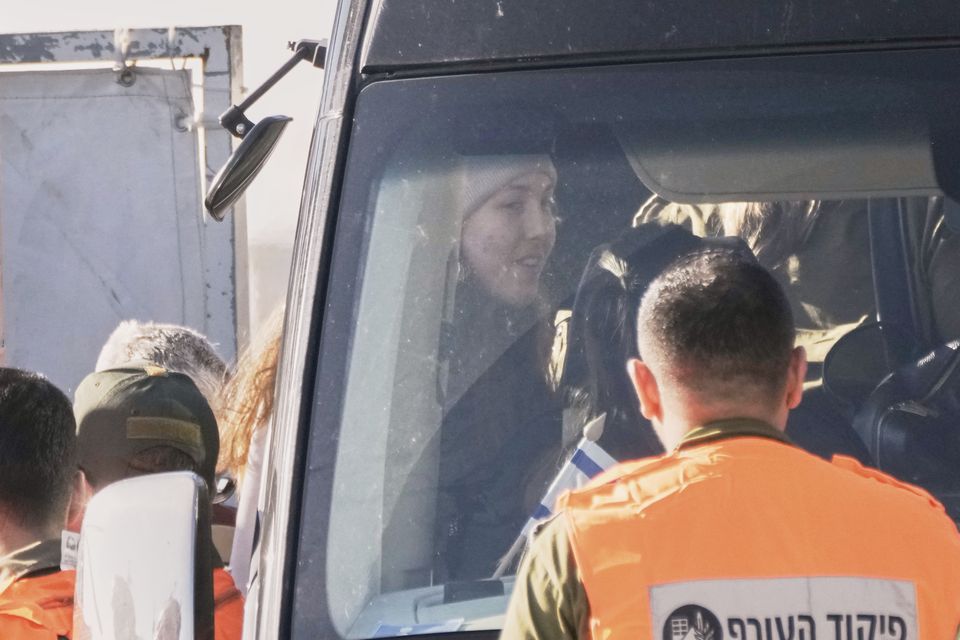 Israeli soldier Naama Levy, who was kidnapped by Hamas, gets on a bus after she and three other Israeli female soldiers were released by Hamas (Leo Correa/AP)