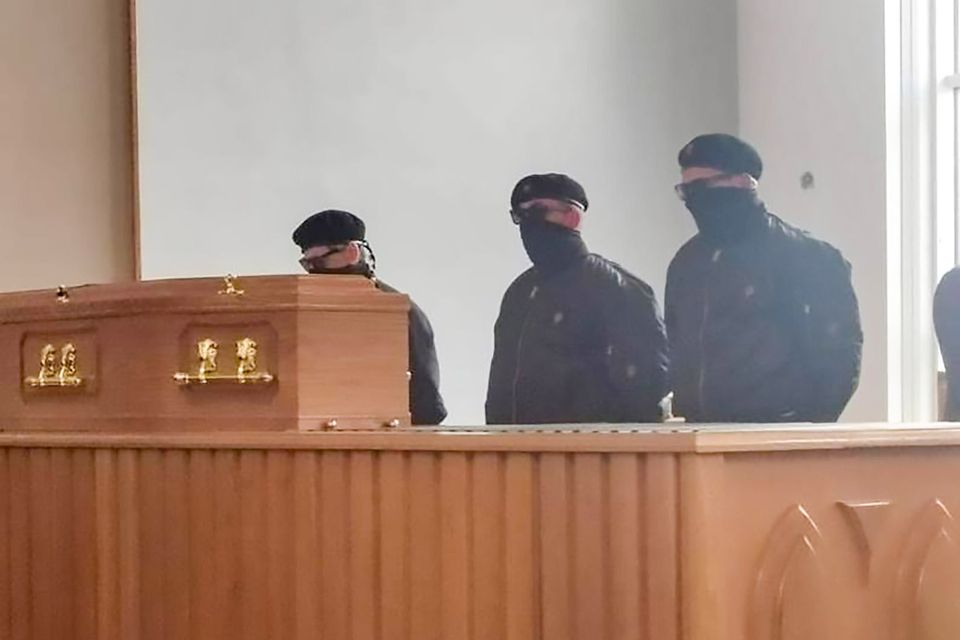 Masked men at a funeral at Roselawn crematorium