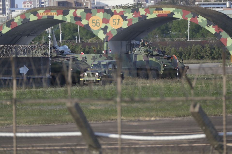 Taiwan army ground force members ride on vehicles at an airbase in Hsinchu, northern Taiwan (Chiang Ying-ying/AP)